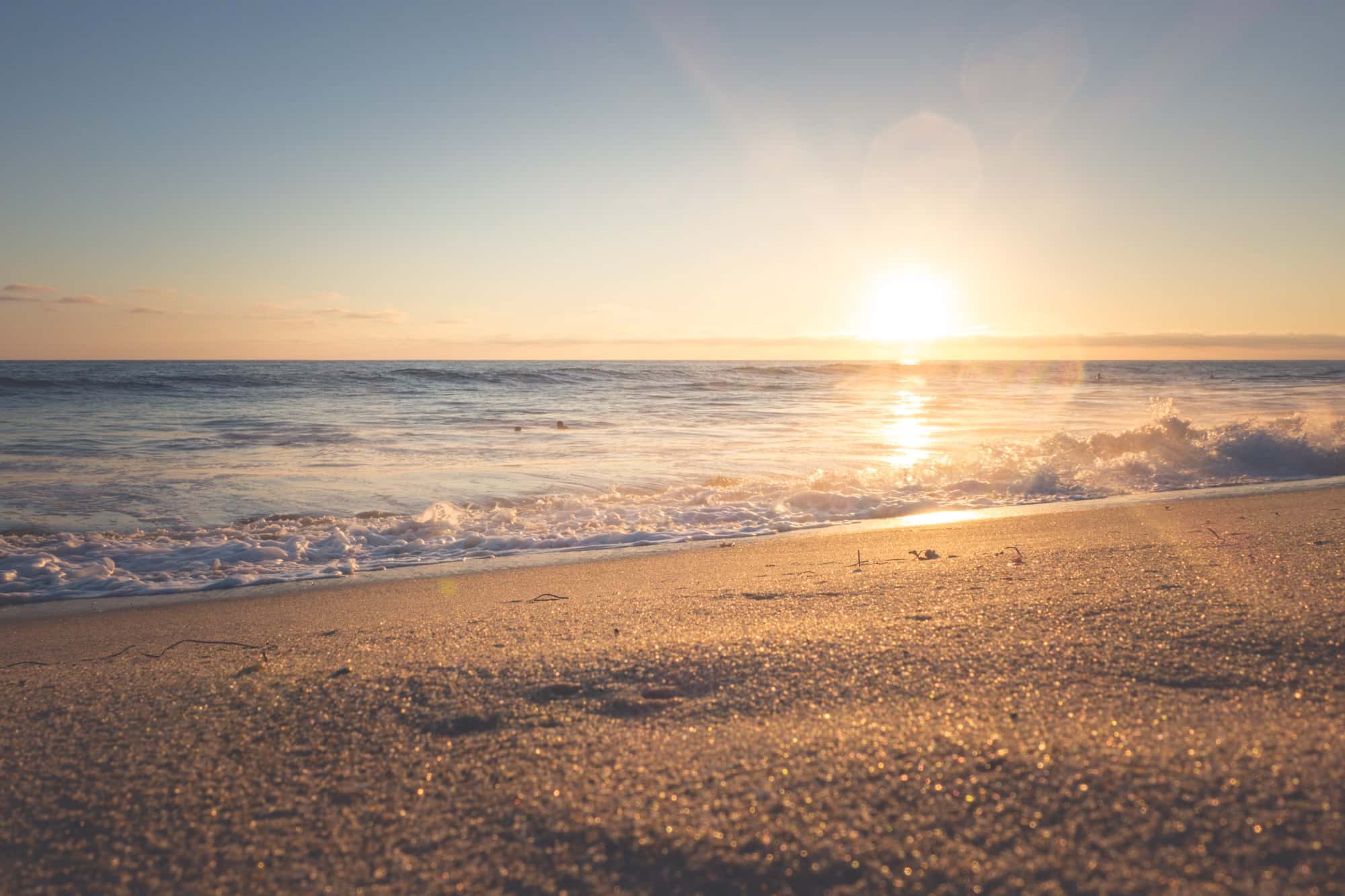 A breathtaking view of the sunset over the horizon where the sea meets the changing hues of the sky.