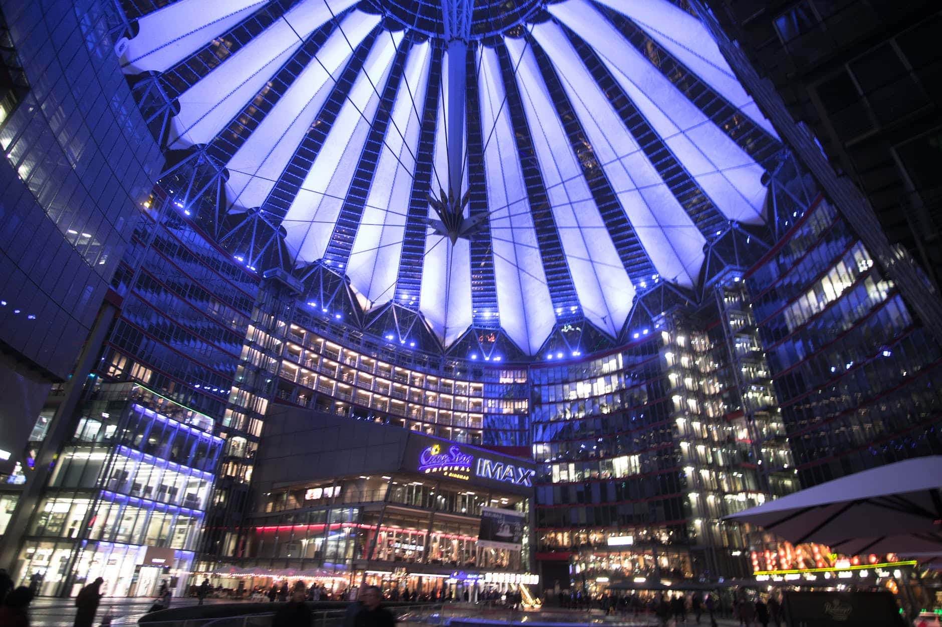 spectacular modern complex with illuminated glass roof at night