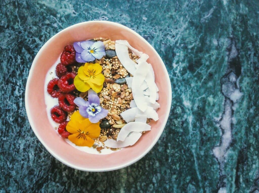 The acai bowl, a popular Hawaiian food in Honolulu, features colorful and nutritious ingredients like fresh fruit, granola, and honey.