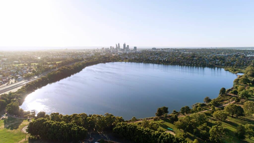 An aerial view of the tranquil, tree-encircled Lake Monger in WA.